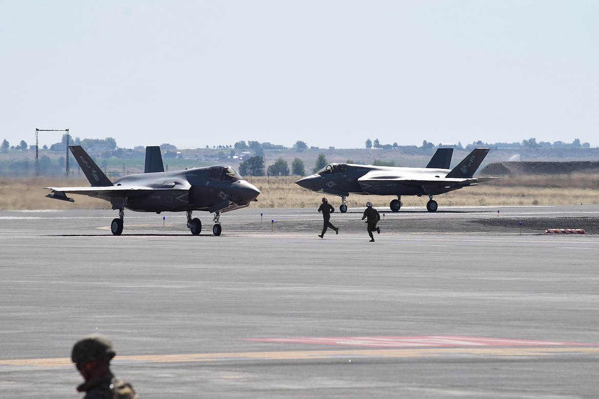 Marine ground crew members prepare to meet a pair of F-35 Lightning IIB fighters as part of the Summer Fury 2021 military exercise at the Grant County International Airport in July 2021.