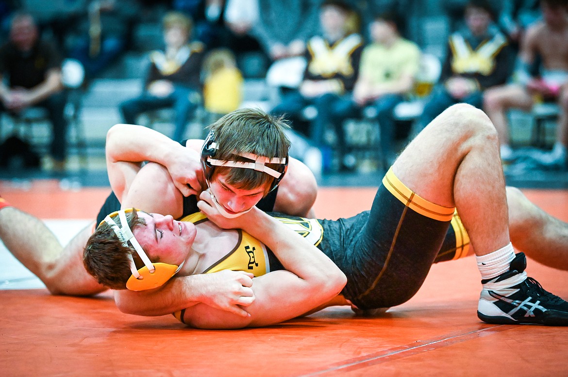 Flathead's Noah Poe-Hatten works toward a pin of Helena Capital's Tuff Adams at 182 pounds at Flathead High School on Friday, Jan. 28. (Casey Kreider/Daily Inter Lake)