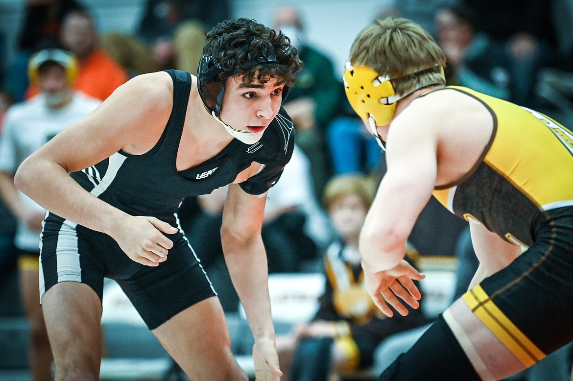 Flathead's Asher Kemppainen looks for an opening against Helena Capital's Carson DesRosier at 138 pounds at Flathead High School on Friday, Jan. 28. (Casey Kreider/Daily Inter Lake)