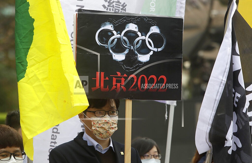 Human right groups gather on the United Nations international Human Rights Day, Friday, Dec. 10, 2021, to call for a boycott of the Beijing Winter Olympics 2022 in front of the Bank of China building in Taipei, Taiwan. Human rights activists issued a call to action against the Beijing Olympics on Friday, Jan. 28, 2022 imploring athletes and sponsors to speak out against what they call the "genocide games." (AP Photo/Chiang Ying-ying, File)