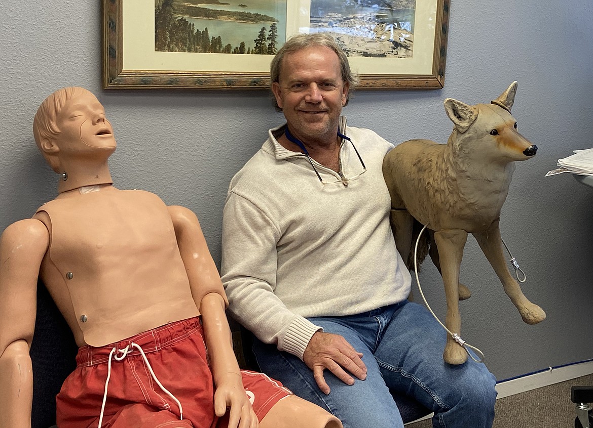 Kim Woodruff sits with a decoy coyote, used at City Beach in an attempt to scare the geese, and one of the practice dummies for the city's lifeguarding program. The longtime Parks and Recreation director is retiring after almost 36 years with the city.