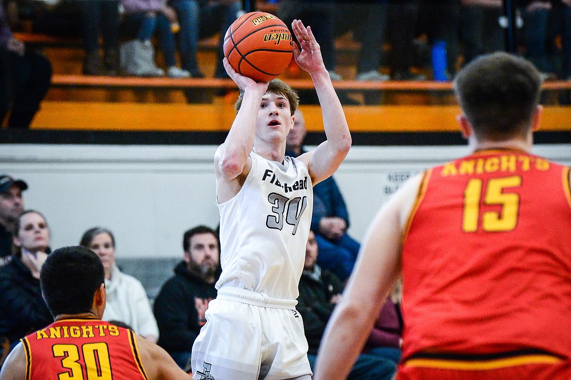 Flathead's Joston Cripe (34) knocks down a three at the end of the second quarter against Missoula Hellgate at Flathead High School on Saturday, Jan. 29. (Casey Kreider/Daily Inter Lake)