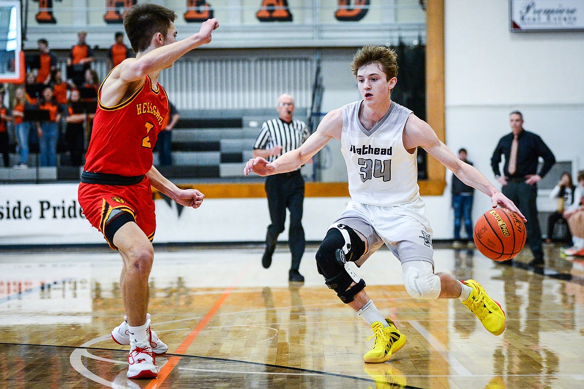 Flathead's Joston Cripe (34) dribbles into the frontcourt guarded by Missoula Hellgate's Asher Topp (2) at Flathead High School on Saturday, Jan. 29. (Casey Kreider/Daily Inter Lake)