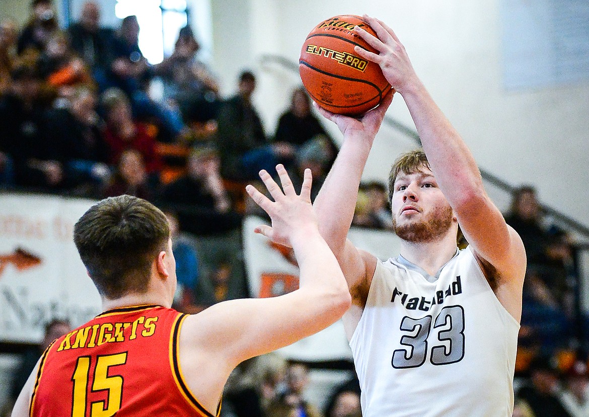 Flathead's Joe Hansen (33) looks to shoot guarded by Missoula Hellgate's Tommy Nilson (15) at Flathead High School on Saturday, Jan. 29. (Casey Kreider/Daily Inter Lake)