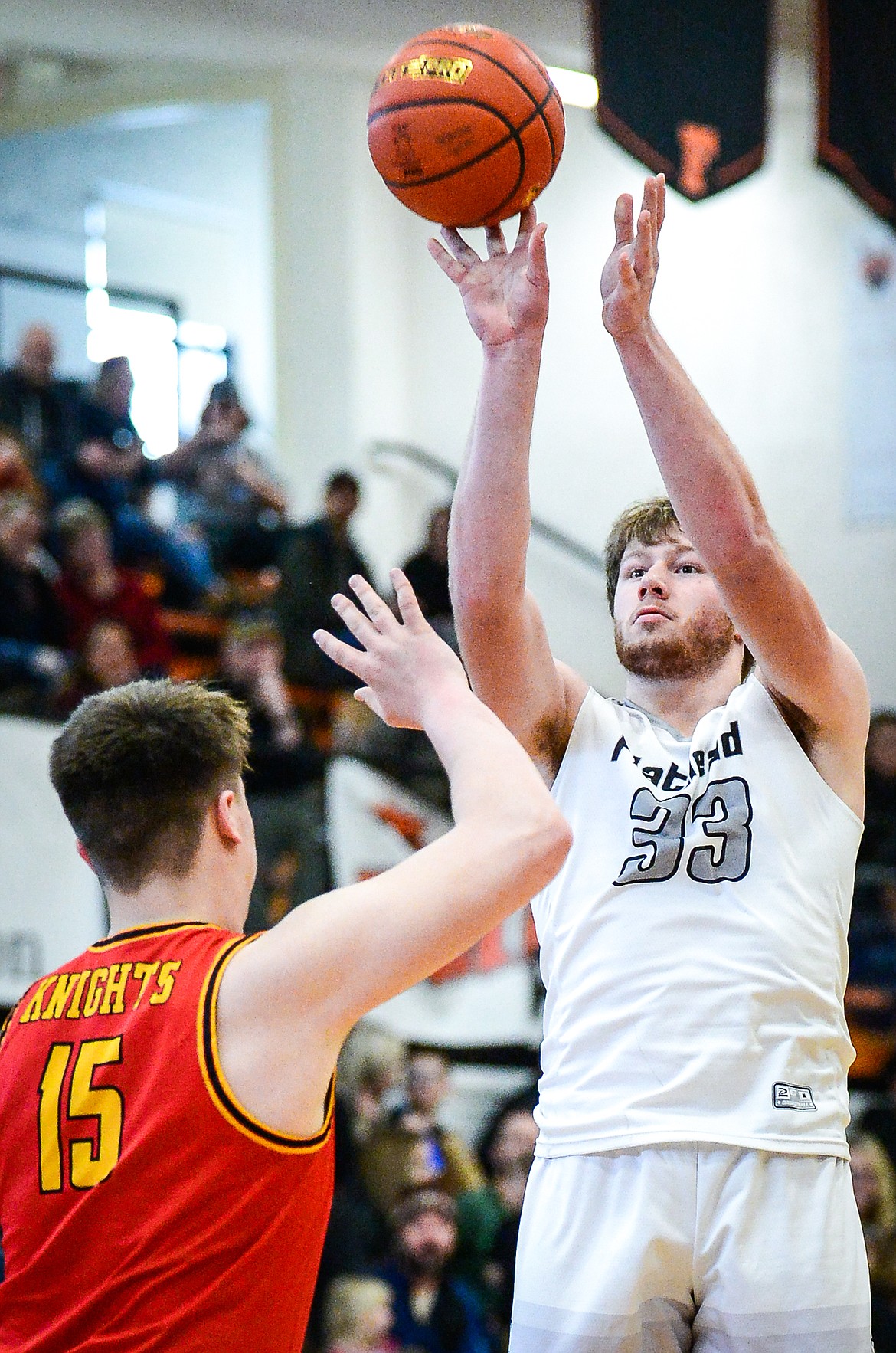 Flathead's Joe Hansen (33) looks to shoot guarded by Missoula Hellgate's Tommy Nilson (15) at Flathead High School on Saturday, Jan. 29. (Casey Kreider/Daily Inter Lake)