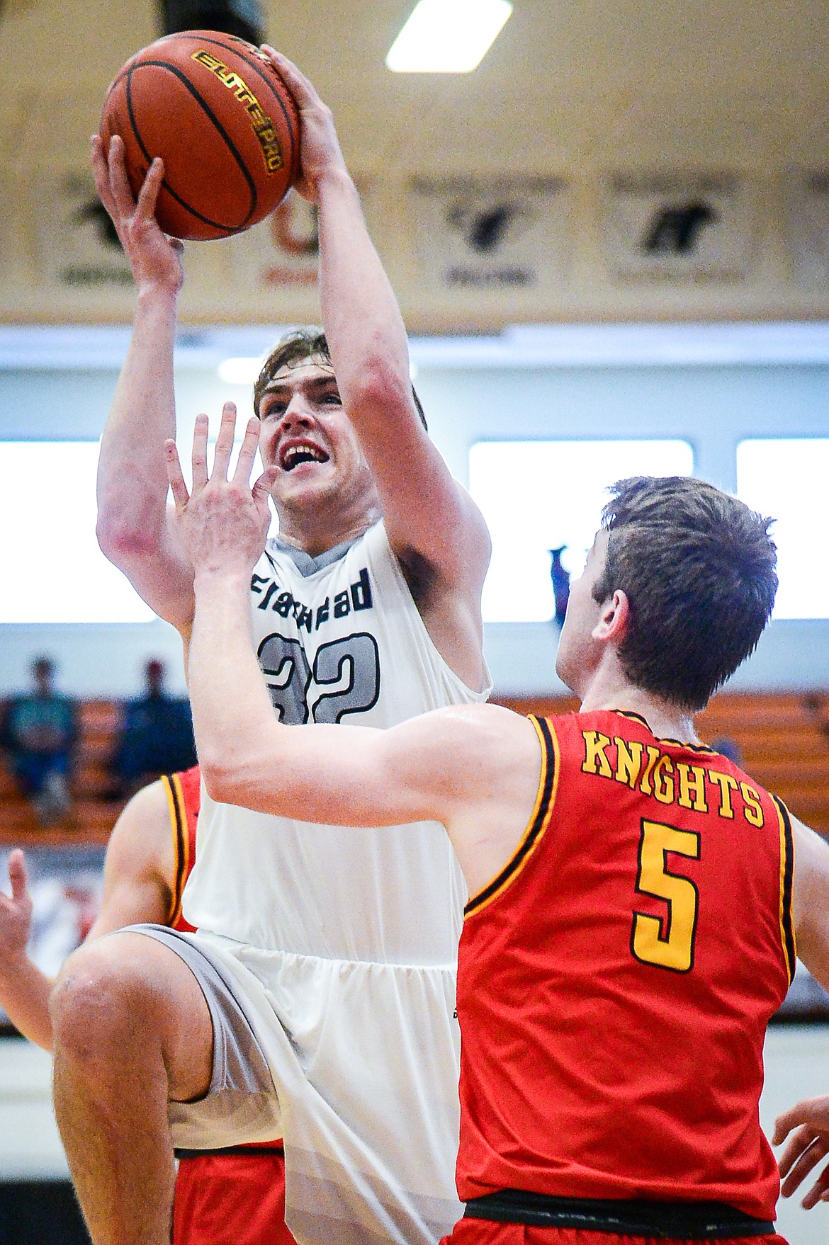 Flathead's Luca Zoeller (32) drives to the basket against Missoula Hellgate's Griffin Kinch (5) at Flathead High School on Saturday, Jan. 29. (Casey Kreider/Daily Inter Lake)