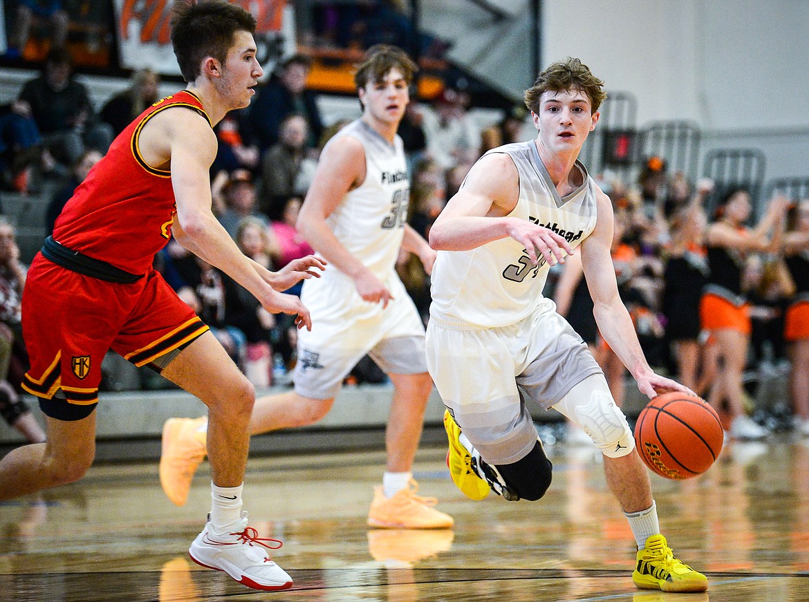 Flathead's Joston Cripe (34) drives into the paint guarded by Missoula Hellgate's Asher Topp (2) at Flathead High School on Saturday, Jan. 29. (Casey Kreider/Daily Inter Lake)