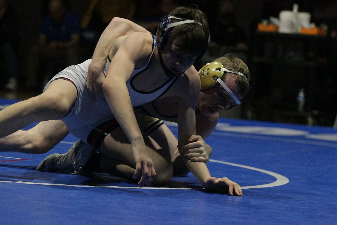 JASON ELLIOTT/Press
Kellogg High senior Wyatt Hei attempts to take down American Falls freshman Mason Aiken during their 113-pound championship match at the North Idaho Rumble on Saturday at Coeur d'Alene High. Hei beat Aiken by a 6-5 decision.