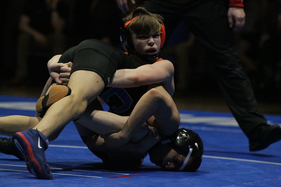 JASON ELLIOTT/Press
Post Falls High freshman Rider Seguine looks to coach Pete Reardon during his 98-pound championship match against Coeur d'Alene senior Christian Kelly at the North Idaho Rumble on Saturday at Coeur d'Alene High. Seguine beat Kelly by a 9-1 major decision.