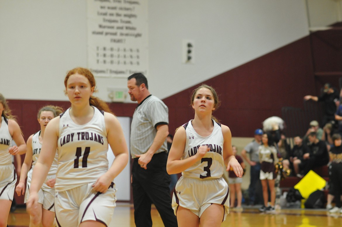 Members of the Troy Lady Trojans come off the court during a 37-25 loss to the Libby Lady Loggers on Jan. 27. (Jim Dasios for The Western News)