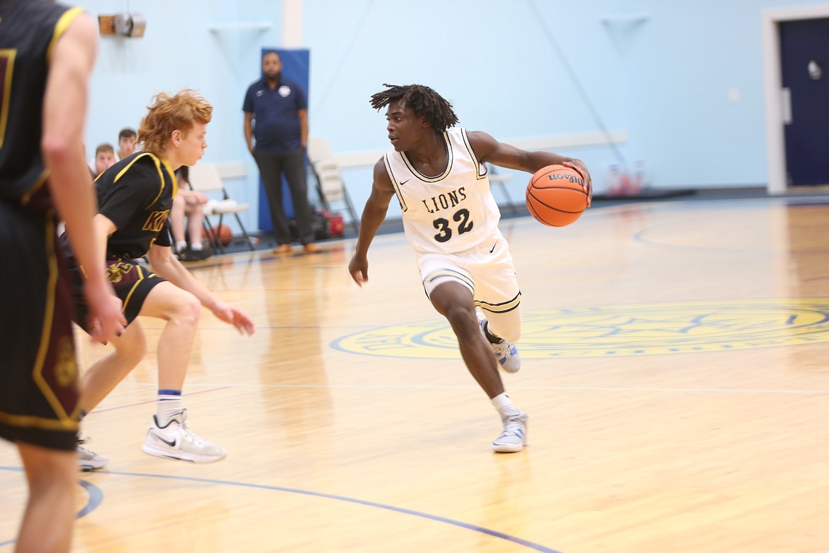 Moses Lake Christian Academy/Covenant Christian School senior Pierre Boorman drives the ball from the top of the key during the game against Sunnyside Christian School on Tuesday.