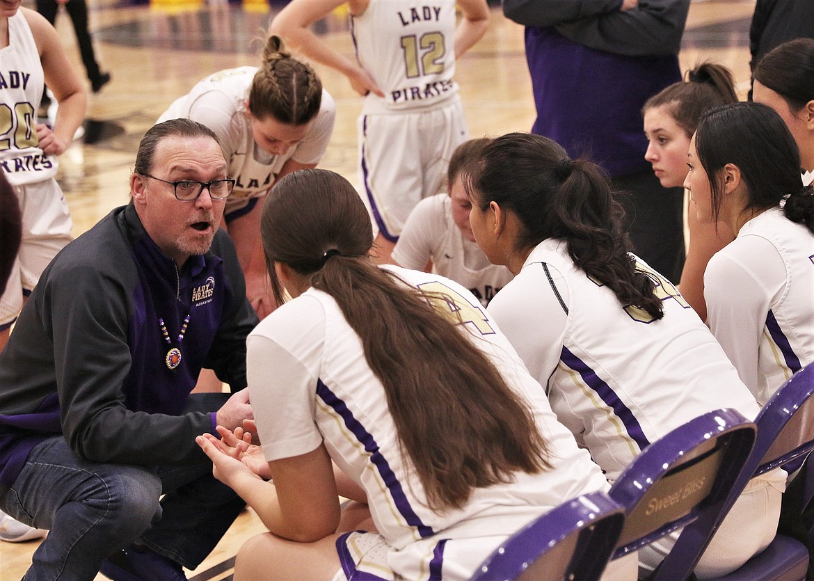 Polson head coach Ryan Antos talks to his team during a timeout. (Courtesy of Bob Gunderson)