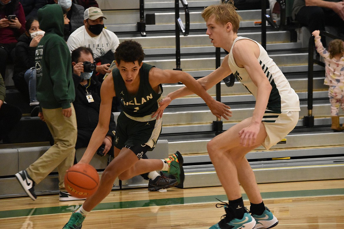 Chelan High School senior Nate Harding (1) dribbles around Quincy High School sophomore Aidan Bews (4) on Tuesday.