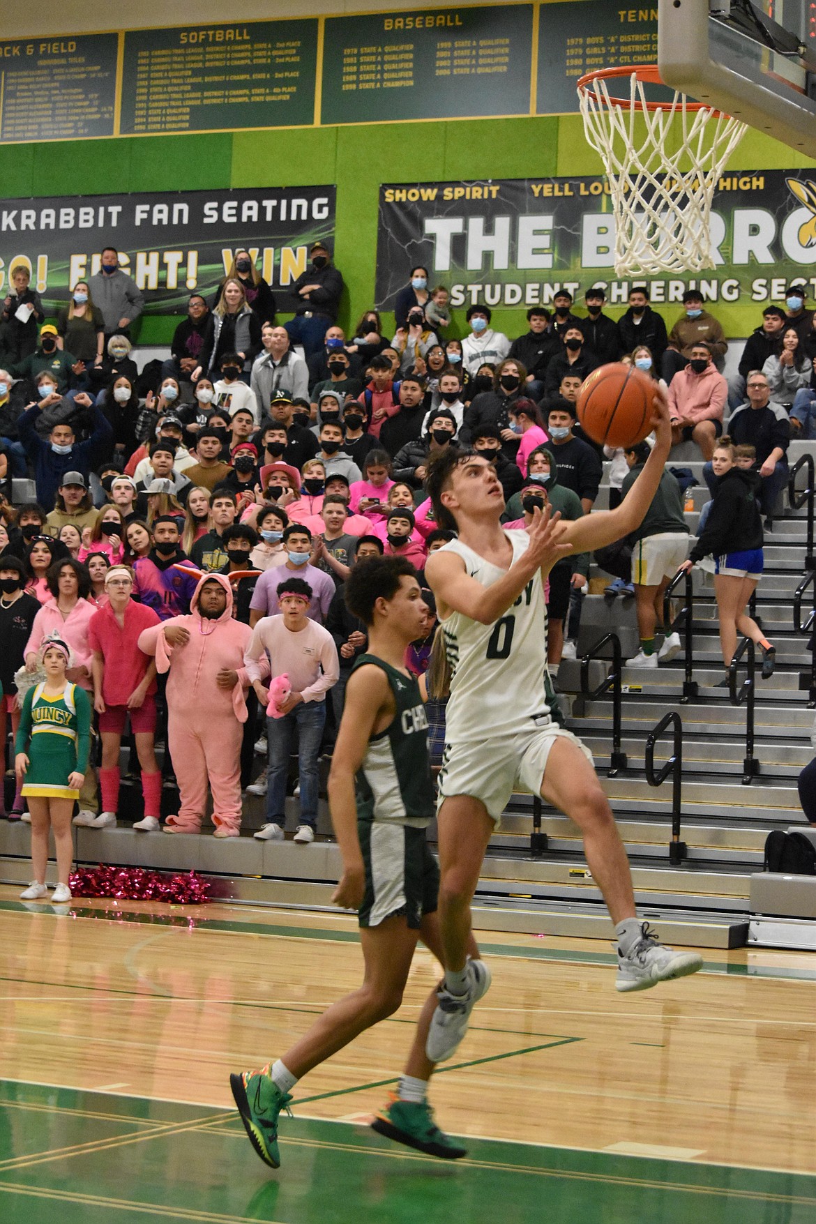 Quincy High School senior Jalen Spence (0) goes in for a layup at the league matchup against Chelan High School on Tuesday.