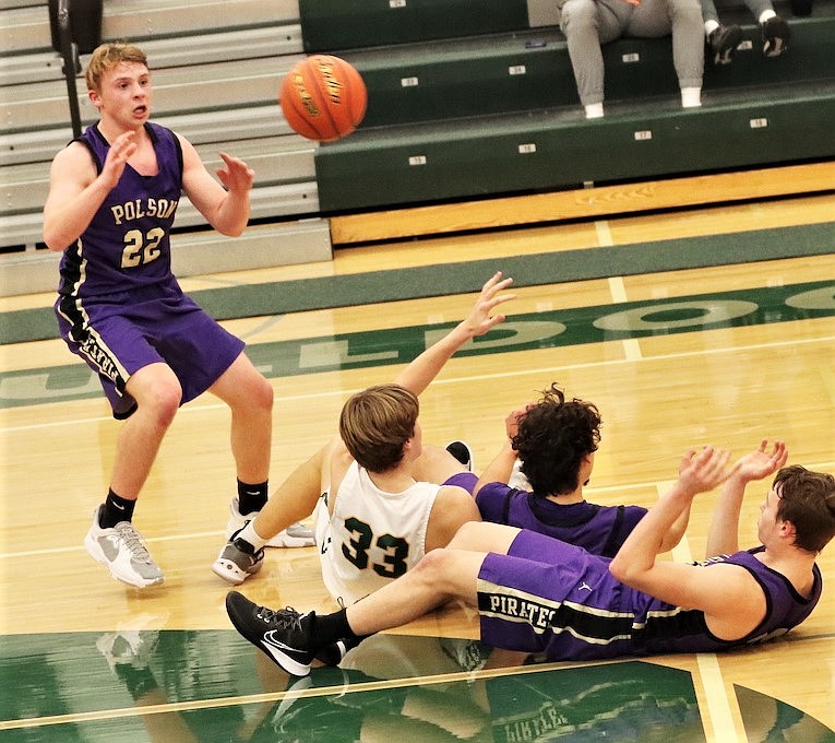 Trent Wilson gains control of the ball after a scramble on the floor against Whitefish. (Courtesy of Niki Graham)