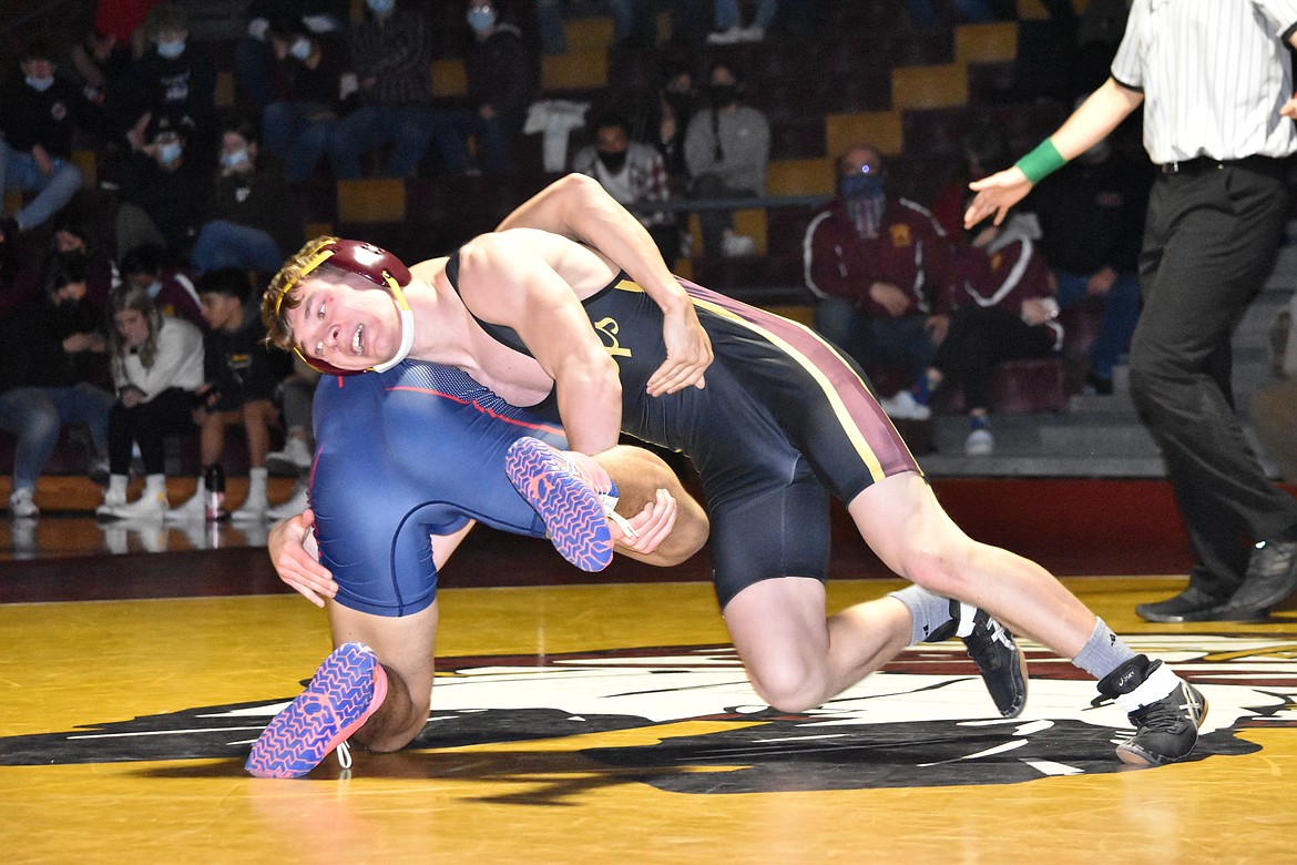 Moses Lake High School senior Derek Grubb wrestles Eisenhower High School’s Jose Olivera on Thursday.