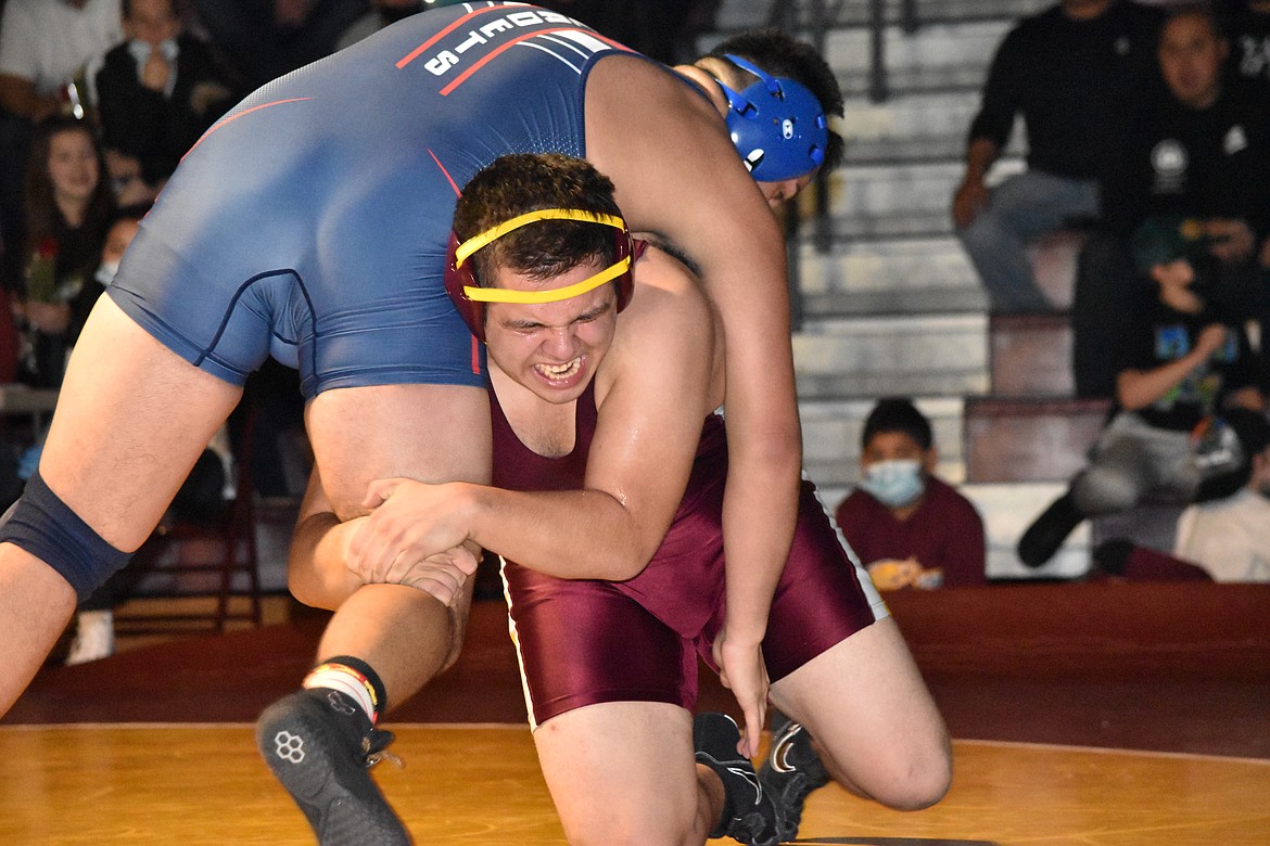 MLHS junior Ashton Sanchez picks his opponent up over his shoulder during the duel against Eisenhower High School on Thursday.