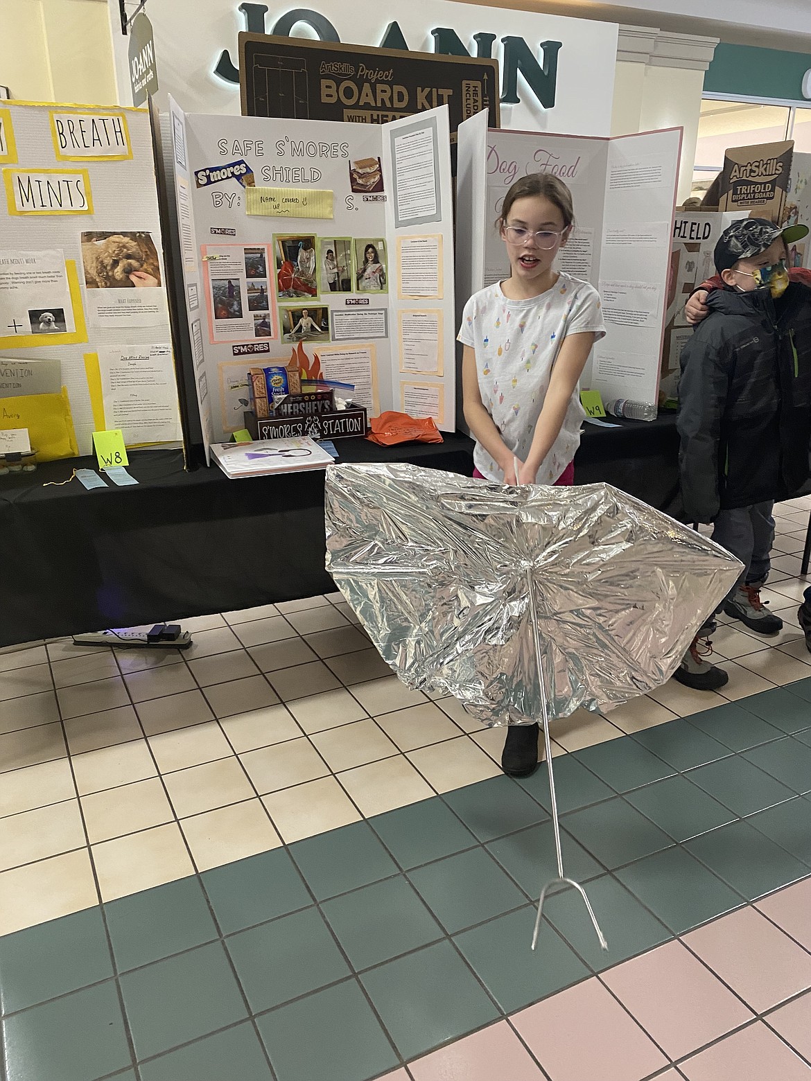 Fifth grader Julianna Schwam, describes the design benefits of her invention, the "Safe S'mores Shield," complete with a telescoping handle. 
"We tested out the invention and it went very good," Schwam said. "Nothing caught on fire."
