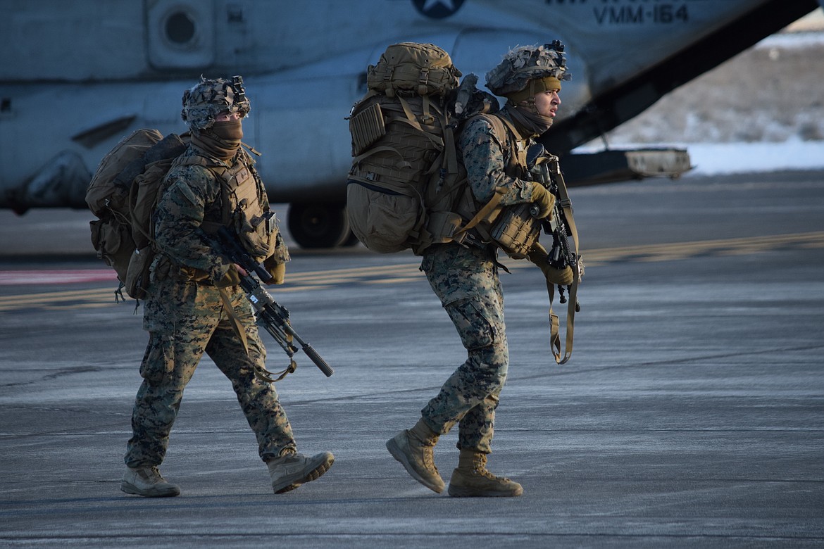 Marines with Charlie Company, 1st Battalion, 4th Regiment based at Camp Pendleton, make their way across the tarmac at the Grant County International Airport on Monday as they deploy for the Winter Fury 22 military exercise in Moses Lake.