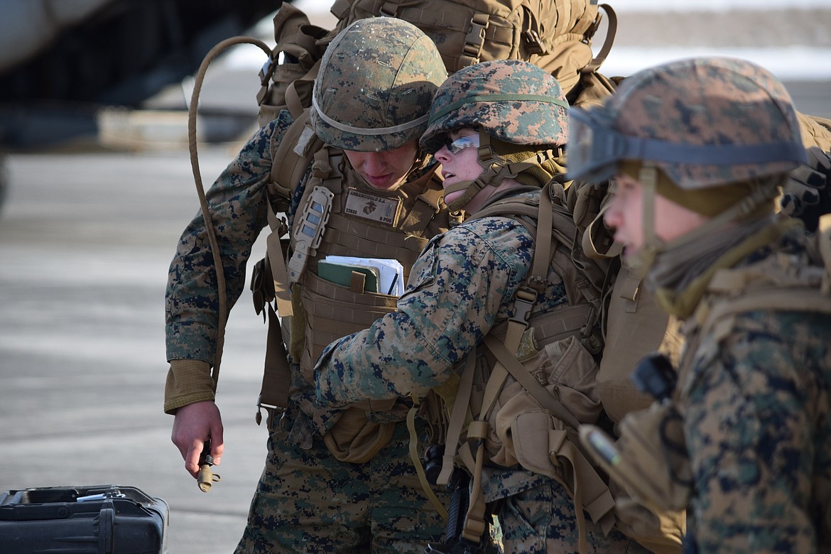 United States Marine Corps Lt. A.J. Anbarcioglu listens to a fellow Marine as they move off the runway at the Grant County International Airport on Monday.