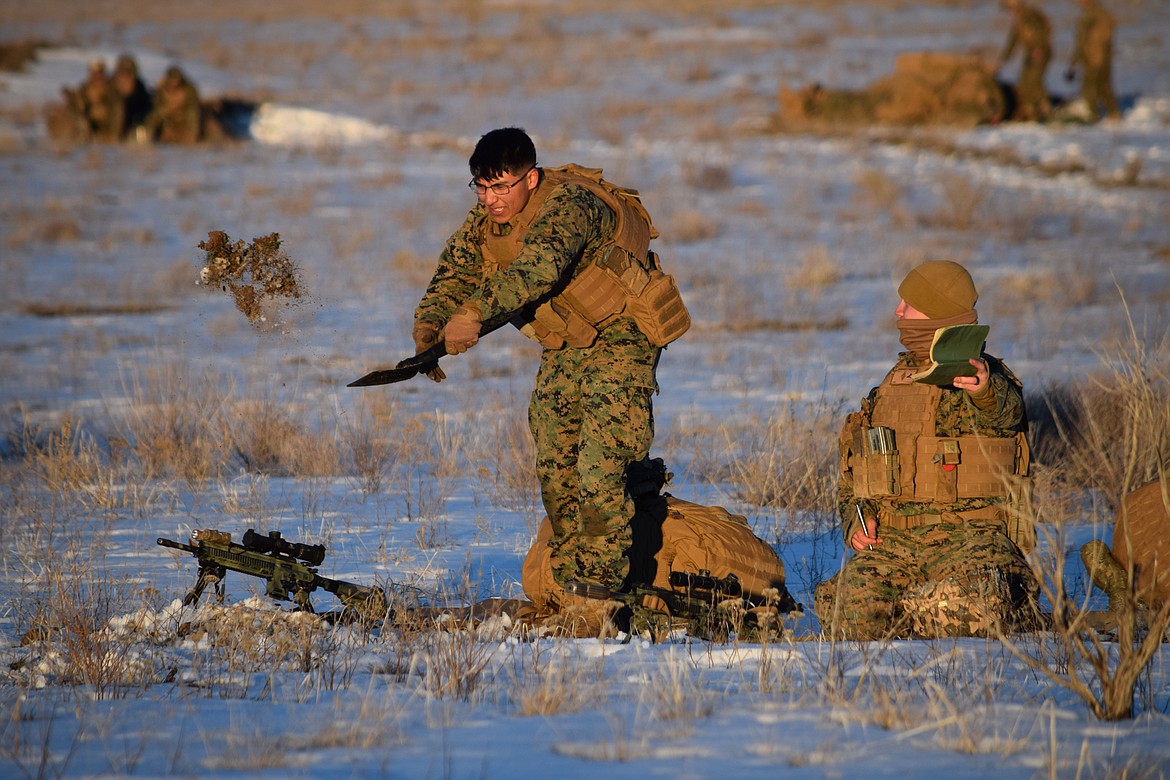 A pair of Marines from Camp Pendleton dig in to create a firing position as part of the Winter Fury 22 military exercise in Moses Lake on Monday.