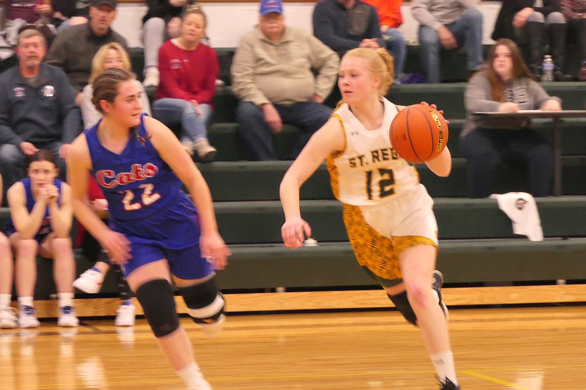 St. Regis guard Macy Hill dribbles by Superior's Lanie Crabb (22) during the Lady Bobcats win Friday night in St. Regis. (Chuck Bandel/Valley Press)