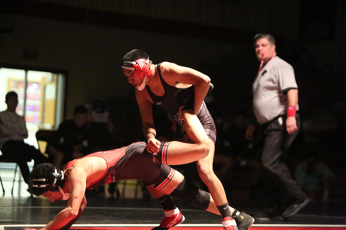 Andy DeLeon Jr., of Othello High School, takes down his opponent Lenin Leon, of East Valley High School, in a dual wrestling meet at Othello on Thursday.