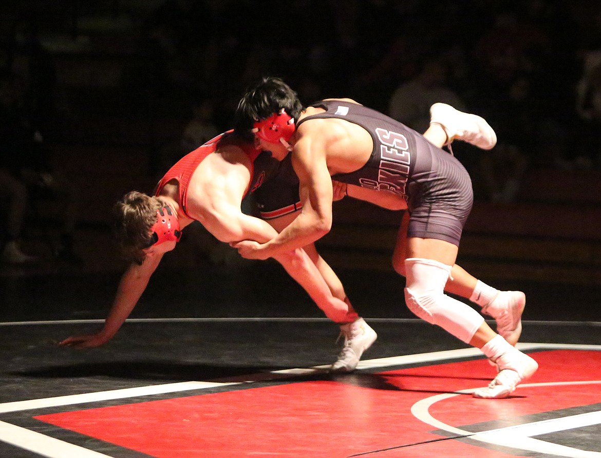 Othello High School wrestler Zak Rocha, right, works to take his opponent J.J. Dobie, of East Valley High School, to the mat in a dual meet Thursday in Othello.