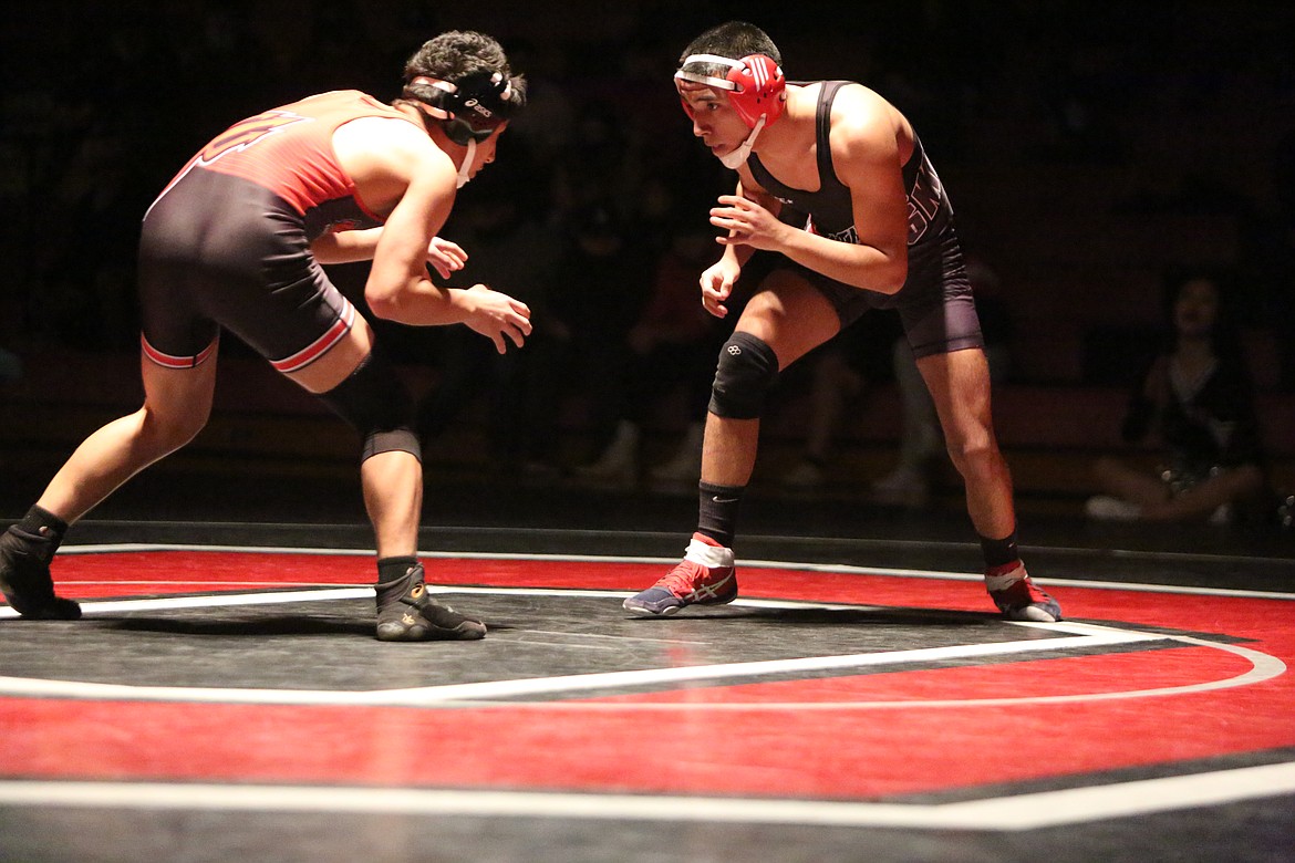 Andy DeLeon Jr., of Othello High School, circles his opponent Lenin Leon, of East Valley High School, in a dual meet in Othello on Thursday.