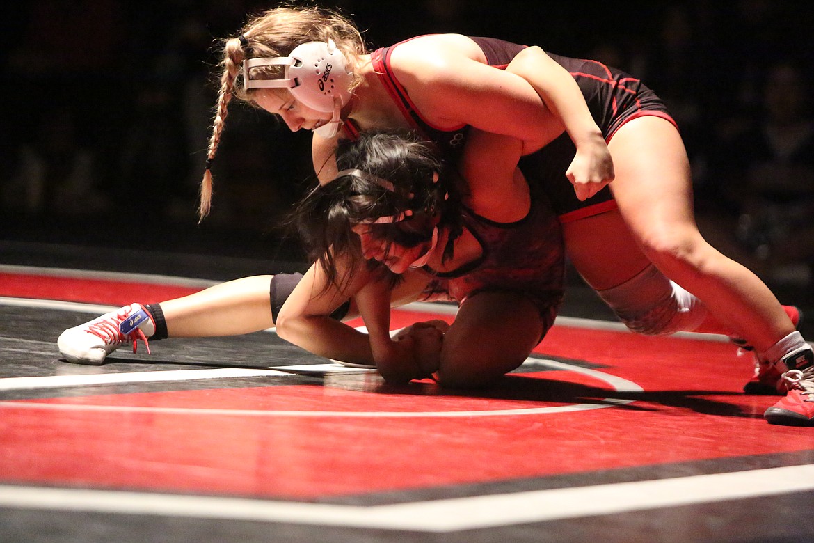 Lexi Monday, top, of Othello High School, works to roll her opponent Elizabet Garcia, of East Valley High School, in a match Thursday in Othello.