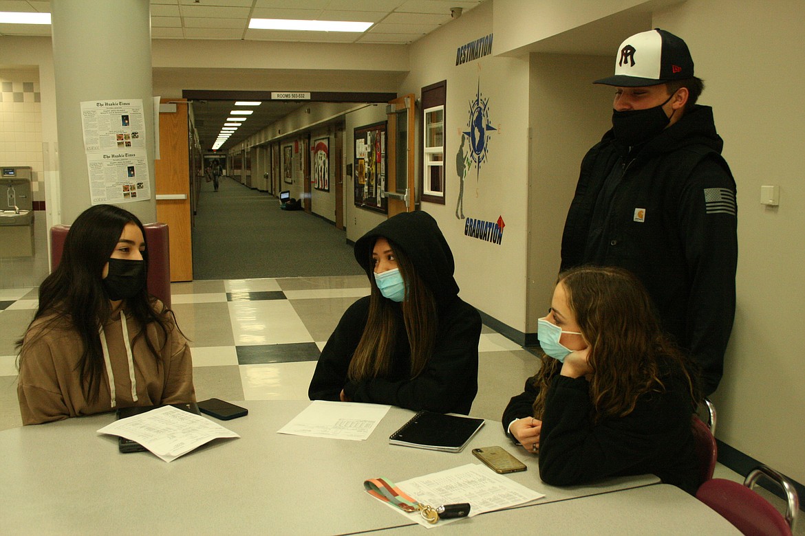 From left: Othello High School students Aileen Segura, Sandy Nieves, Robert Suarez and Julissa Valdez talk about scheduling in the OHS cafeteria Friday.