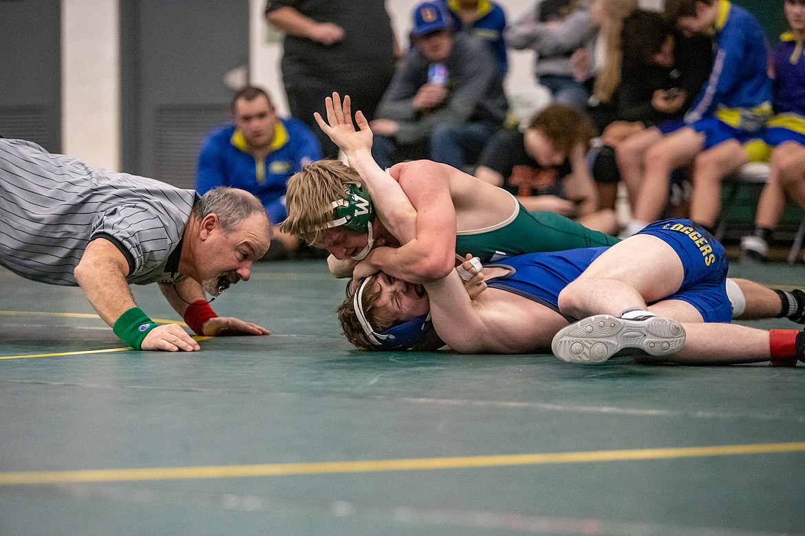 Whitefish senior Carter Moran pins a Libby Logger wrestler at the Whitefish Duals meet on Friday. (JP Edge photo)