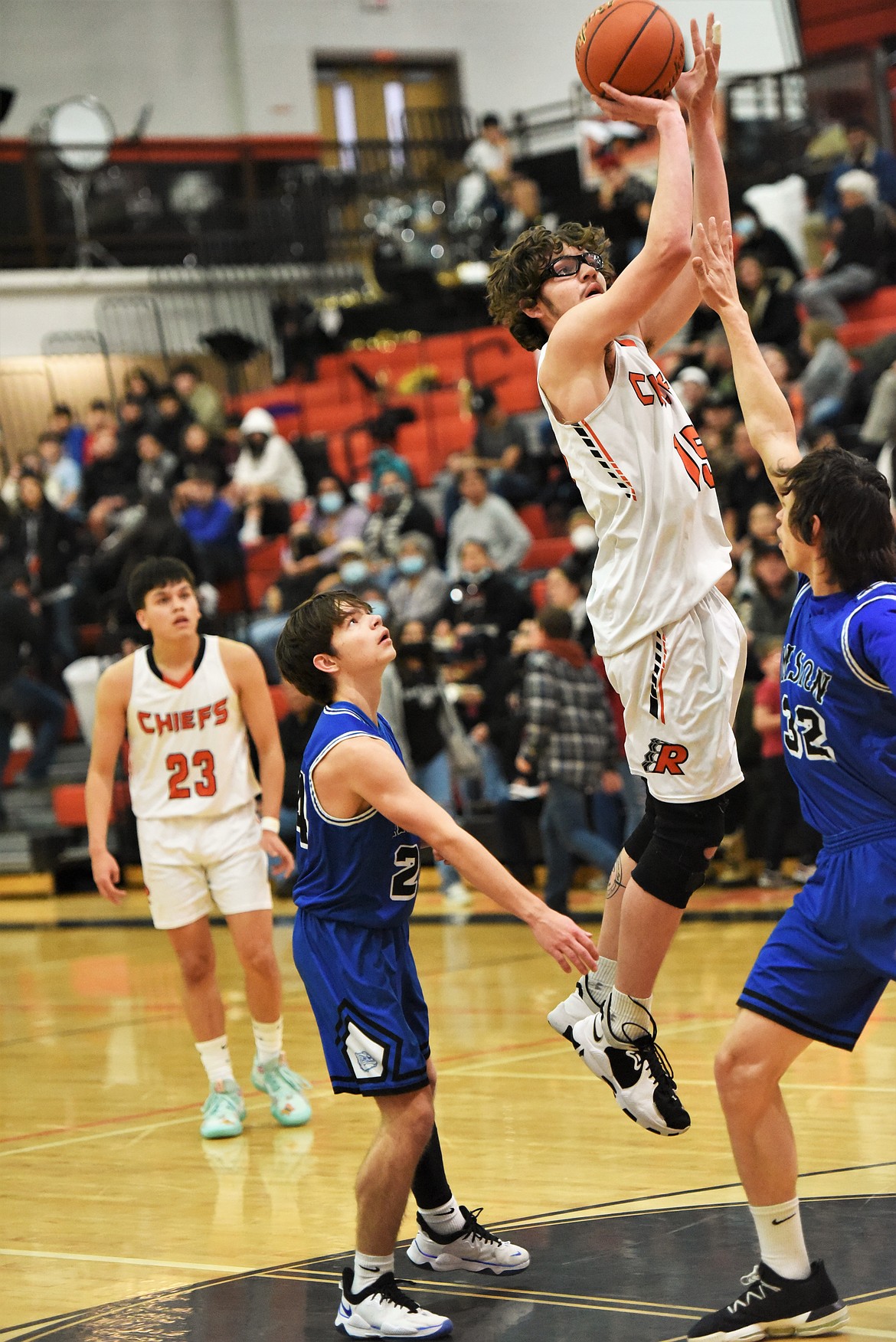 The Chiefs' Payton Cates puts up a jumper in front of Mission's Zoran LaFrombois (24) and Justin Brown (32) as teammate Elijah Tonasket watches in the background. (Scot Heisel/Lake County Leader)