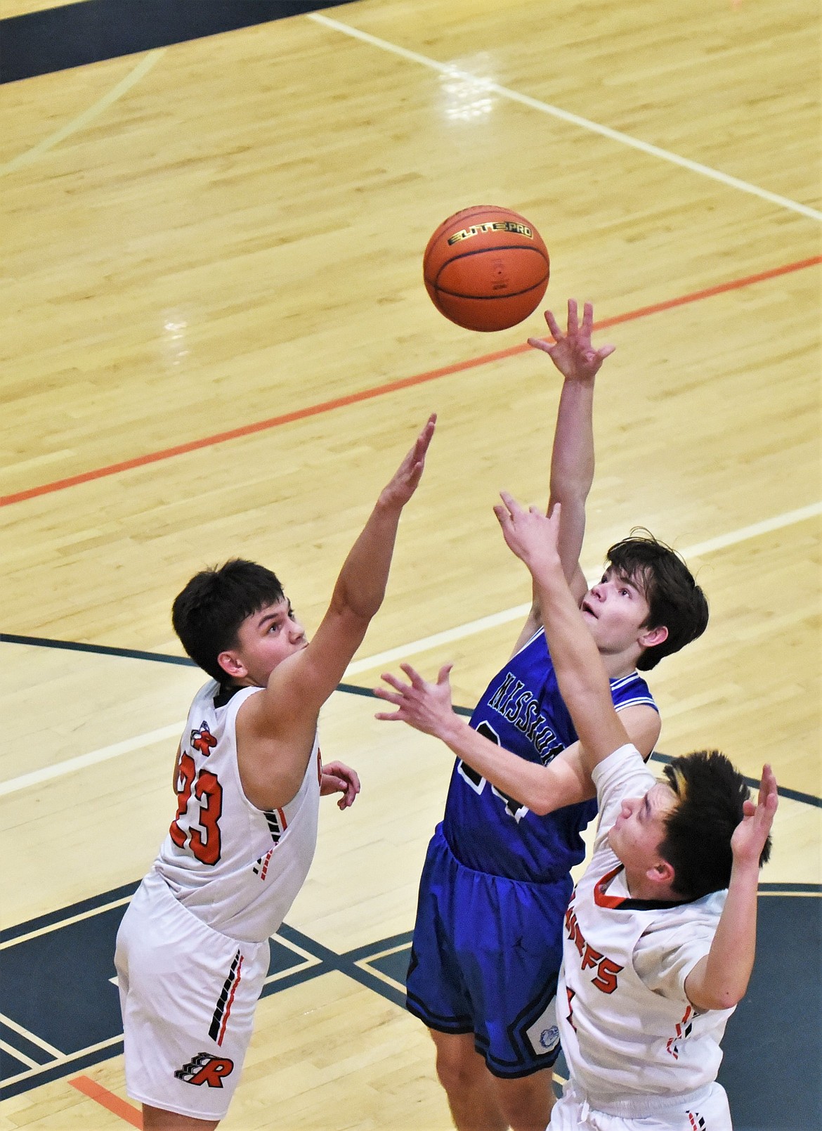 Zoran LaFrombois puts up a shot over Ronan's Elijah Tonasket, left, and Jordan Gatch. (Scot Heisel/Lake County Leader)