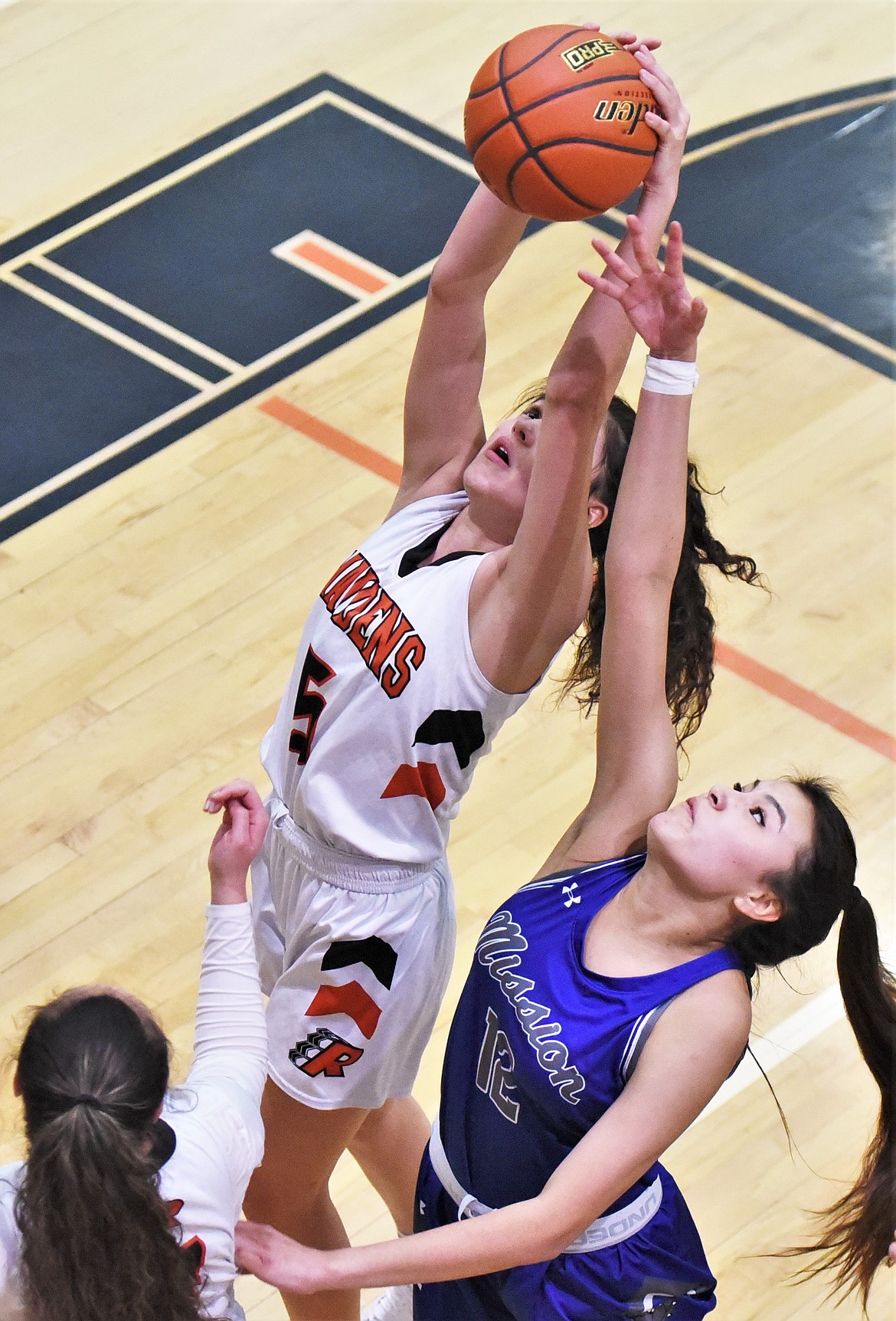 Ronan's LaReina Cordova snags a rebound in front of Mission's Cedar Hunt. (Scot Heisel/Lake County Leader)