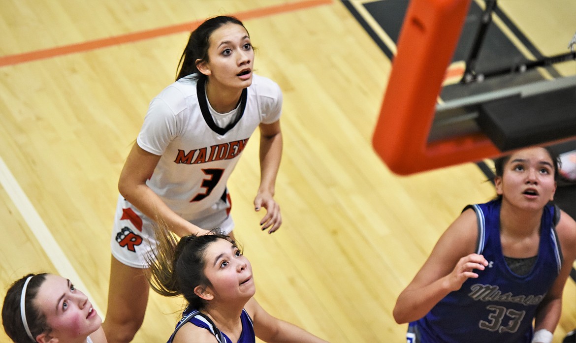 Ronan's Olivia Heiner, left, and Leina Ulutoa look for a rebound along with Mission's Kason Page and Olivia Adams (33). (Scot Heisel/Lake County Leader)