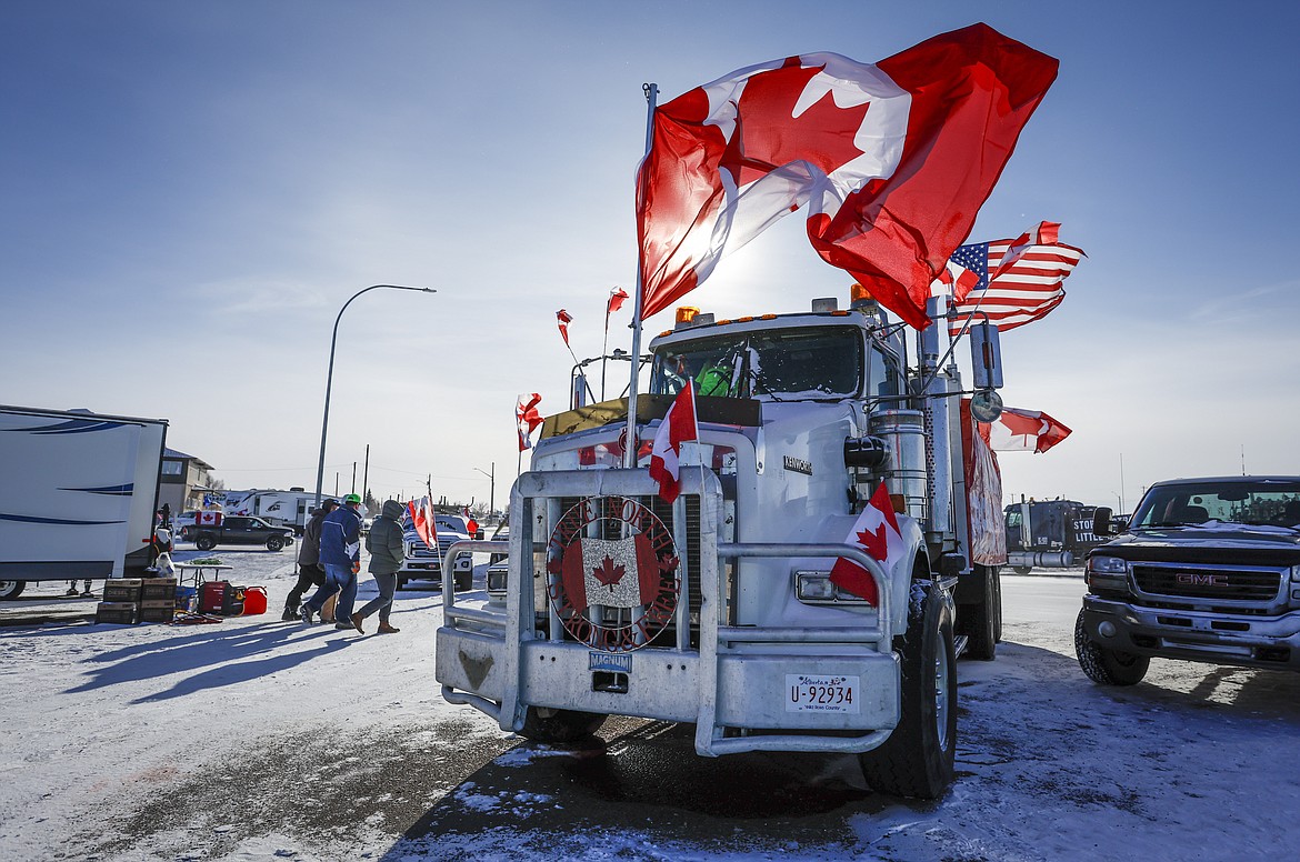 The last truck blocking the southbound lane moves after a breakthrough resolved the impasse where anti-COVID-19 vaccine mandate demonstrators blocked the highway at the busy U.S. border crossing in Coutts, Alberta, Wednesday, Feb. 2, 2022. (Jeff McIntosh /The Canadian Press via AP)