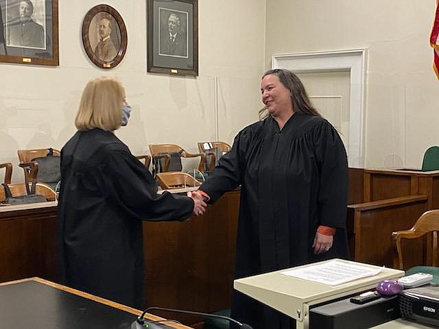 Newly sworn-in Shoshone County District Judge Barbara Duggan (right) shakes hands with Bonner County District Judge Barbara Buchanan following Duggan's investiture on Wednesday night.