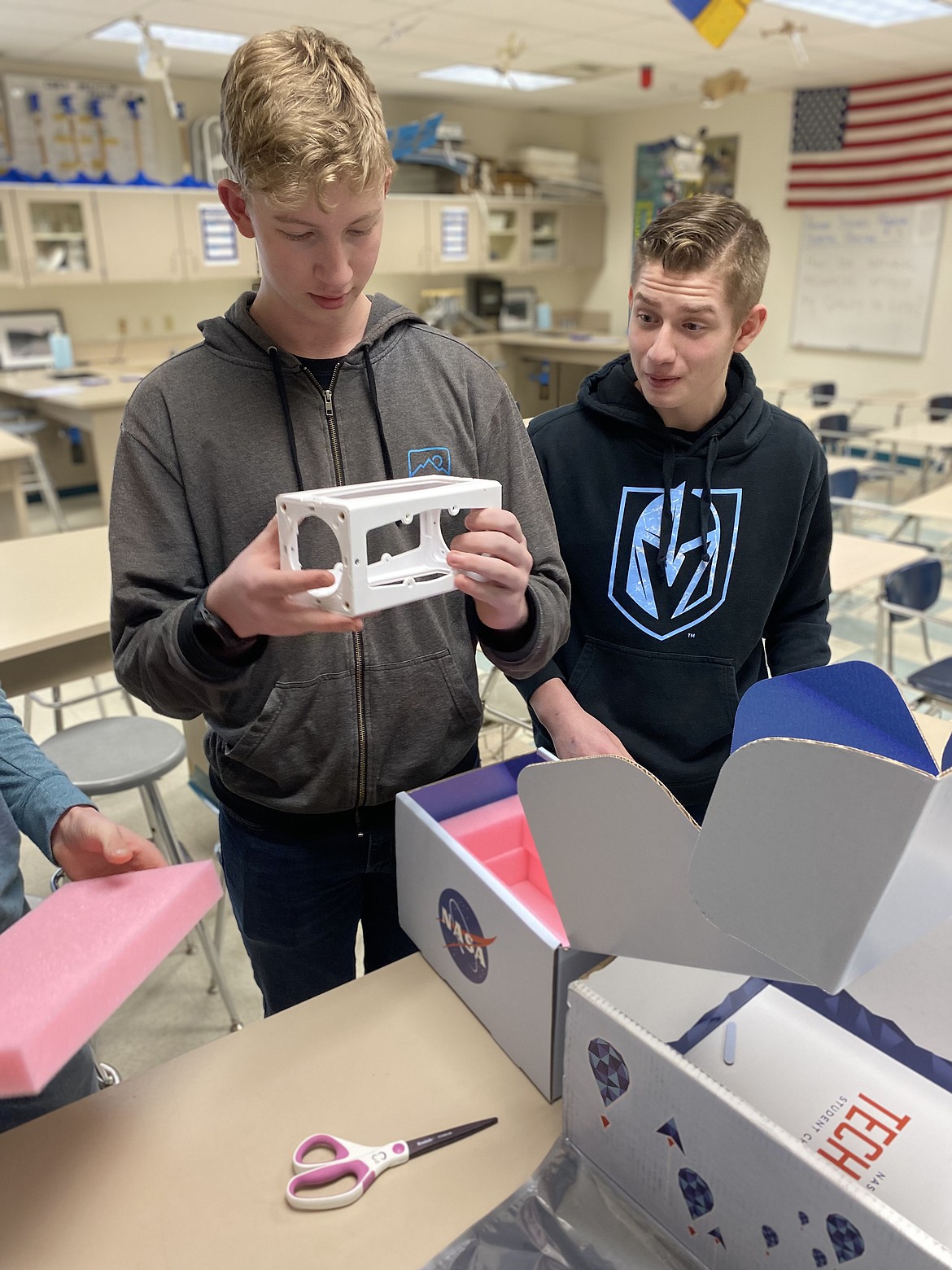 From left, Lake City High School sophomores George Lanigan and Parker Morville open a box from NASA, a kit to make their project, Testing Air Quality, Chemical Composition, and Pollutants. Photo courtesy of Jamie Esler