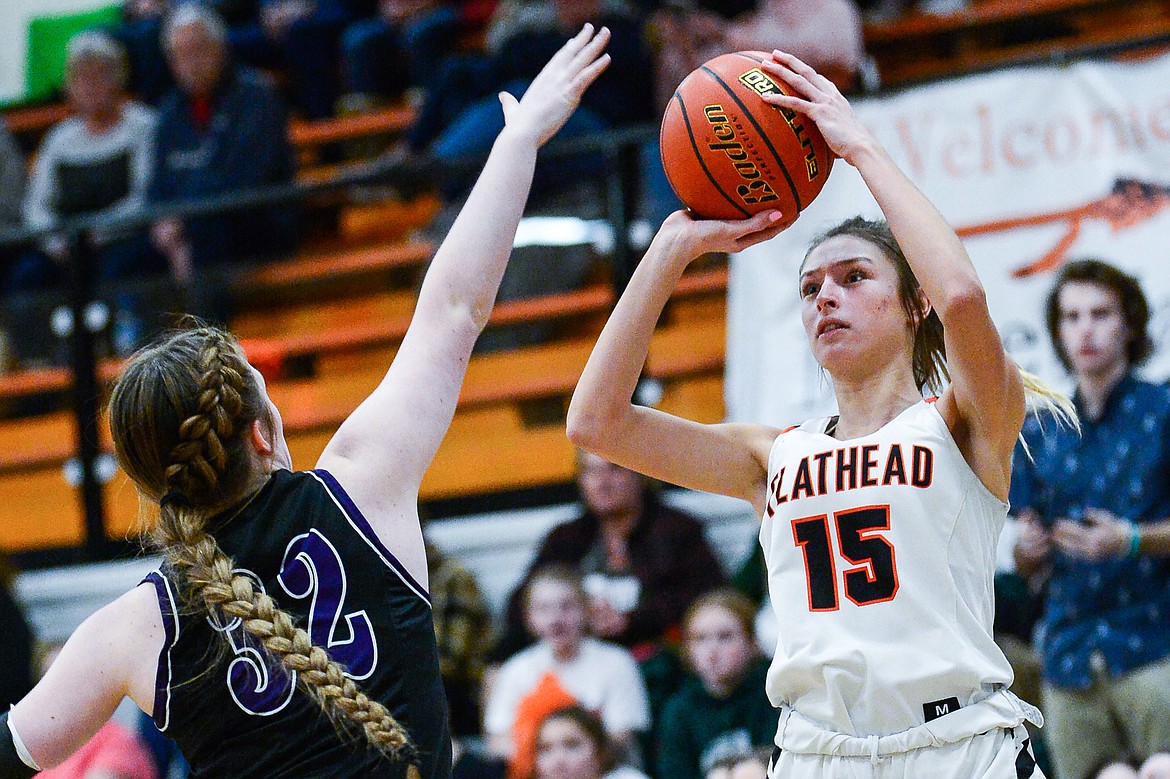 Flathead's Clare Converse (15) looks to shoot over Butte's Rian Ferriter (32) at Flathead High School on Friday, Feb. 4. (Casey Kreider/Daily Inter Lake)