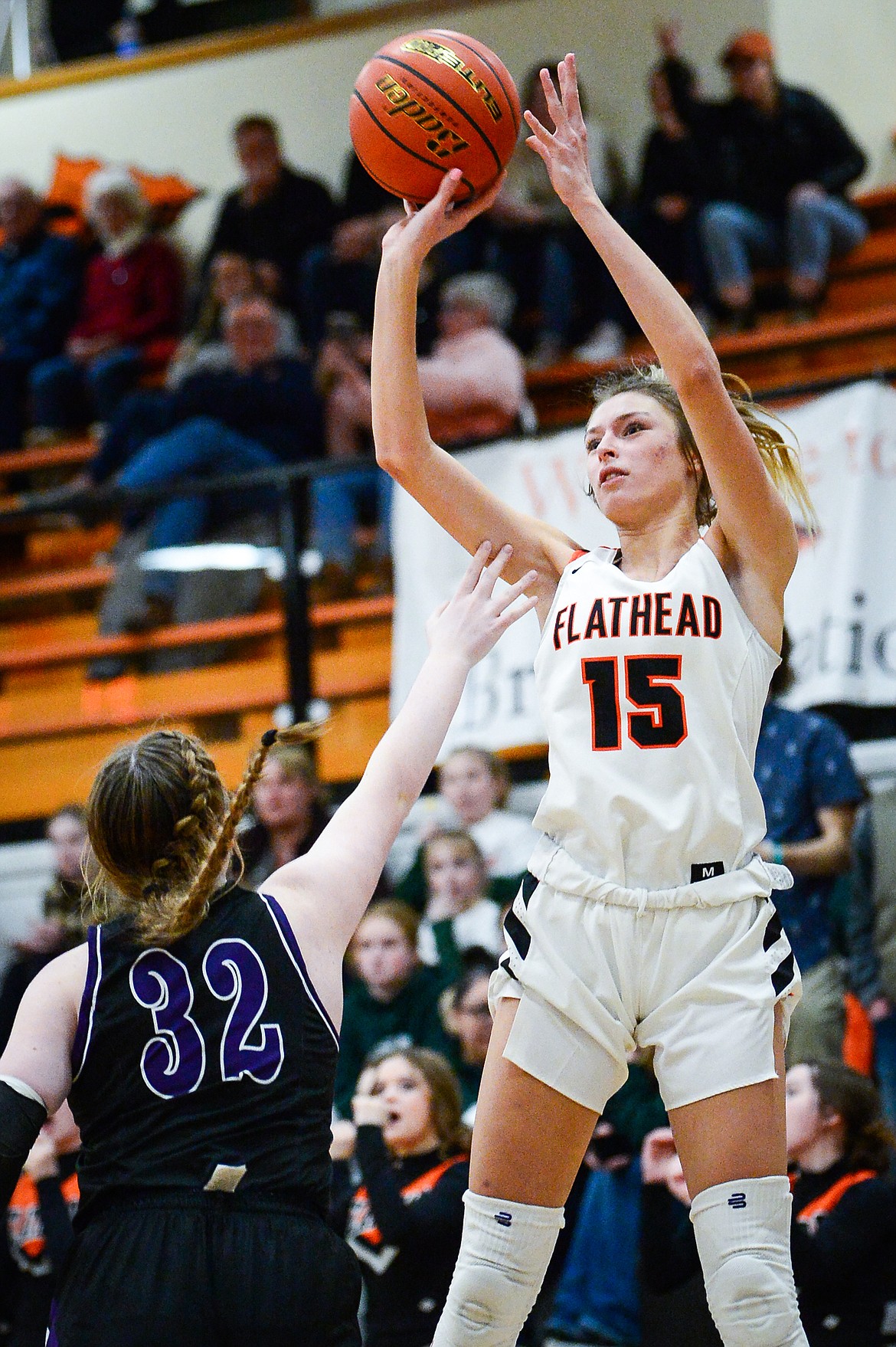 Flathead's Clare Converse (15) looks to shoot over Butte's Rian Ferriter (32) at Flathead High School on Friday, Feb. 4. (Casey Kreider/Daily Inter Lake)