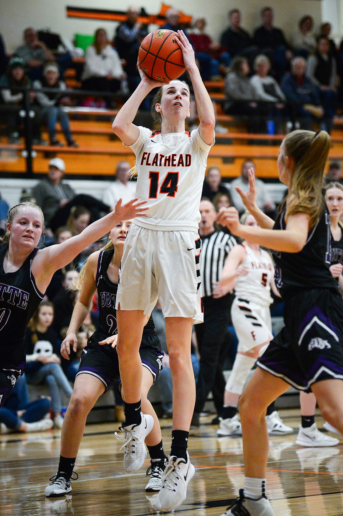 Flathead's Kennedy Moore (14) looks to shoot between Butte defenders at Flathead High School on Friday, Feb. 4. (Casey Kreider/Daily Inter Lake)