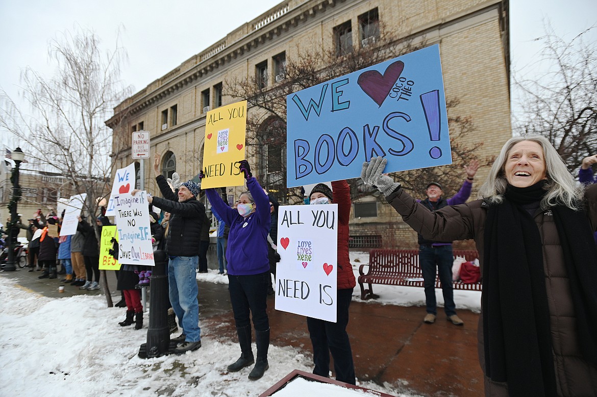 People gather to hold signs of support outside ImagineIF Library in Kalispell on Saturday, Feb. 5. (Casey Kreider/Daily Inter Lake)