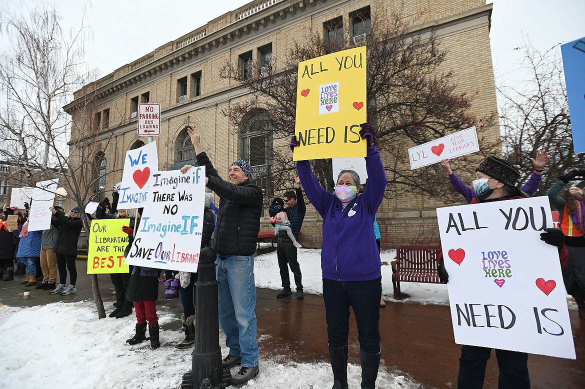 People gather to hold signs of support outside ImagineIF Library in Kalispell on Saturday, Feb. 5. (Casey Kreider/Daily Inter Lake)