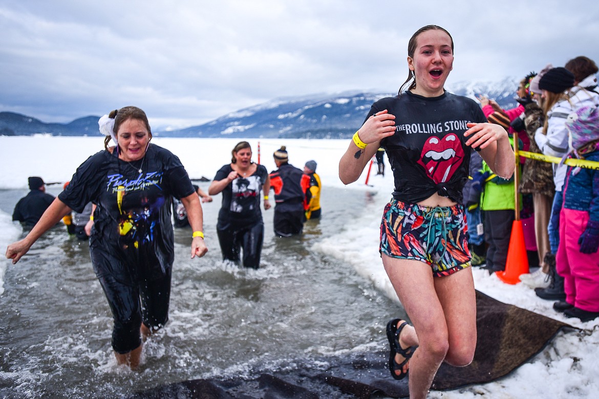 Participants step out of Whitefish Lake during the Penguin Plunge on Saturday, Feb. 5. Organized by the Law Enforcement Torch Run as part of the Whitefish Winter Carnival, the event raised over $60,000 for Special Olympics Montana. (Casey Kreider/Daily Inter Lake)