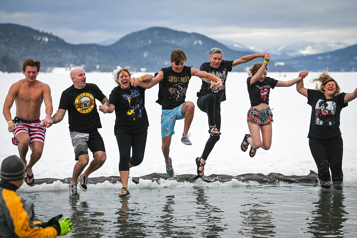 Participants leap into Whitefish Lake during the Penguin Plunge on Saturday, Feb. 5. Organized by the Law Enforcement Torch Run, as part of the Whitefish Winter Carnival, the event raised over $60,000 for Special Olympics Montana. (Casey Kreider/Daily Inter Lake)