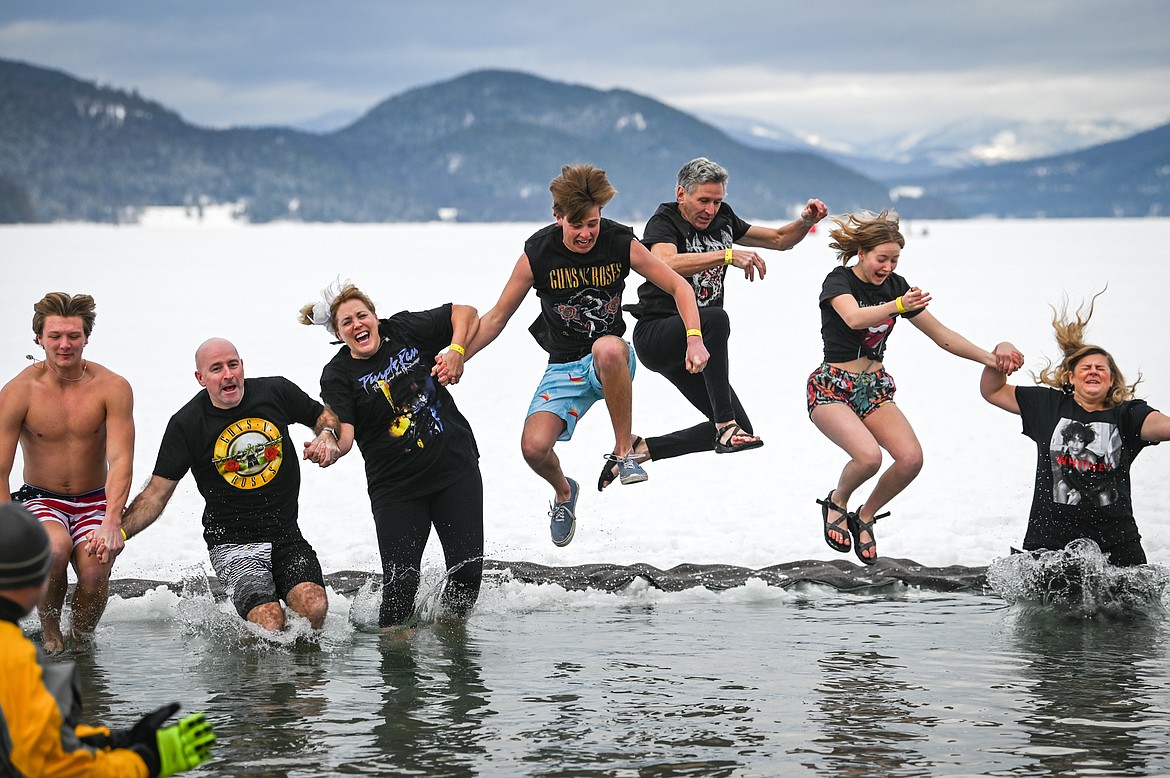 Participants leap into Whitefish Lake during the Penguin Plunge on Saturday, Feb. 5. Organized by the Law Enforcement Torch Run, as part of the Whitefish Winter Carnival, the event raised over $60,000 for Special Olympics Montana. (Casey Kreider/Daily Inter Lake)