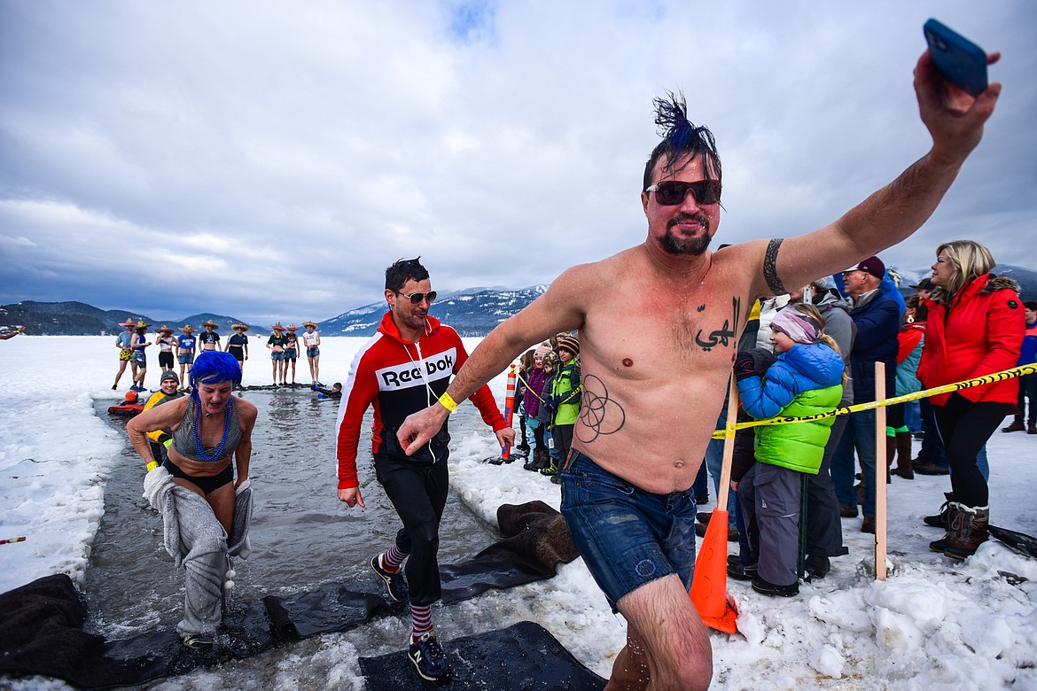 Participants step out of Whitefish Lake during the Penguin Plunge on Saturday, Feb. 5. Organized by the Law Enforcement Torch Run as part of the Whitefish Winter Carnival, the event raised over $60,000 for Special Olympics Montana. (Casey Kreider/Daily Inter Lake)