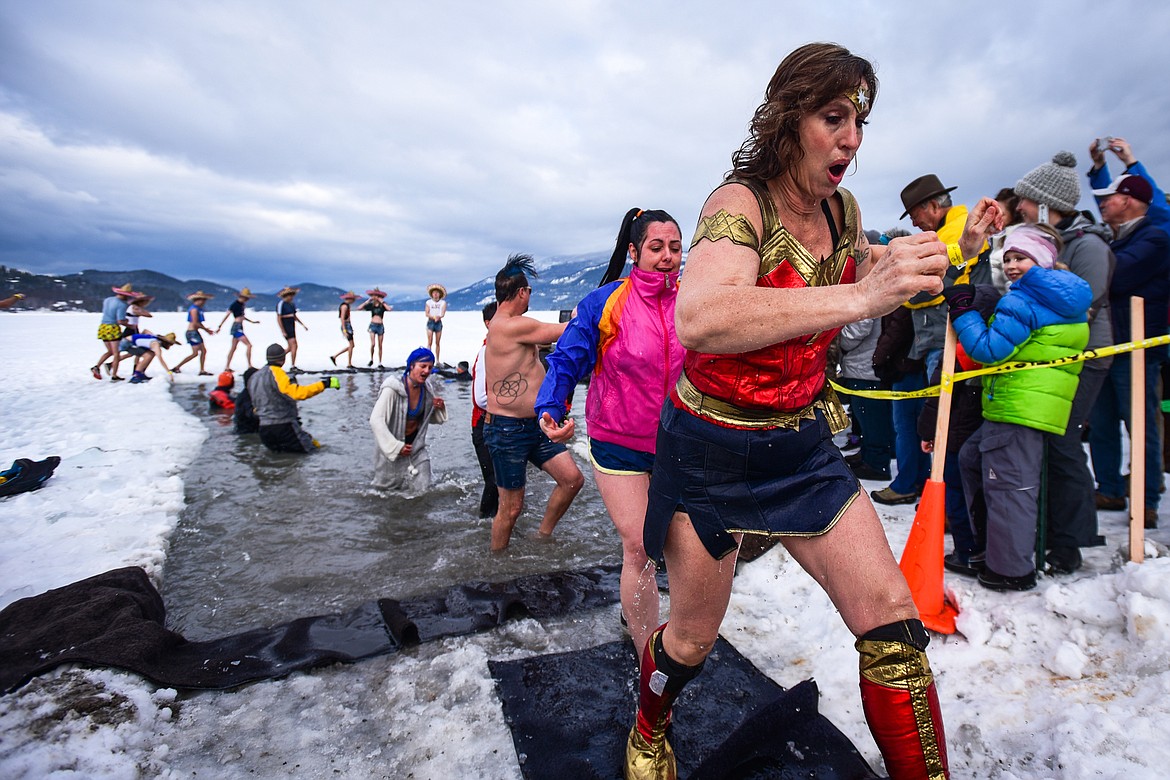 Participants step out of Whitefish Lake during the Penguin Plunge on Saturday, Feb. 5. Organized by the Law Enforcement Torch Run as part of the Whitefish Winter Carnival, the event raised over $60,000 for Special Olympics Montana. (Casey Kreider/Daily Inter Lake)