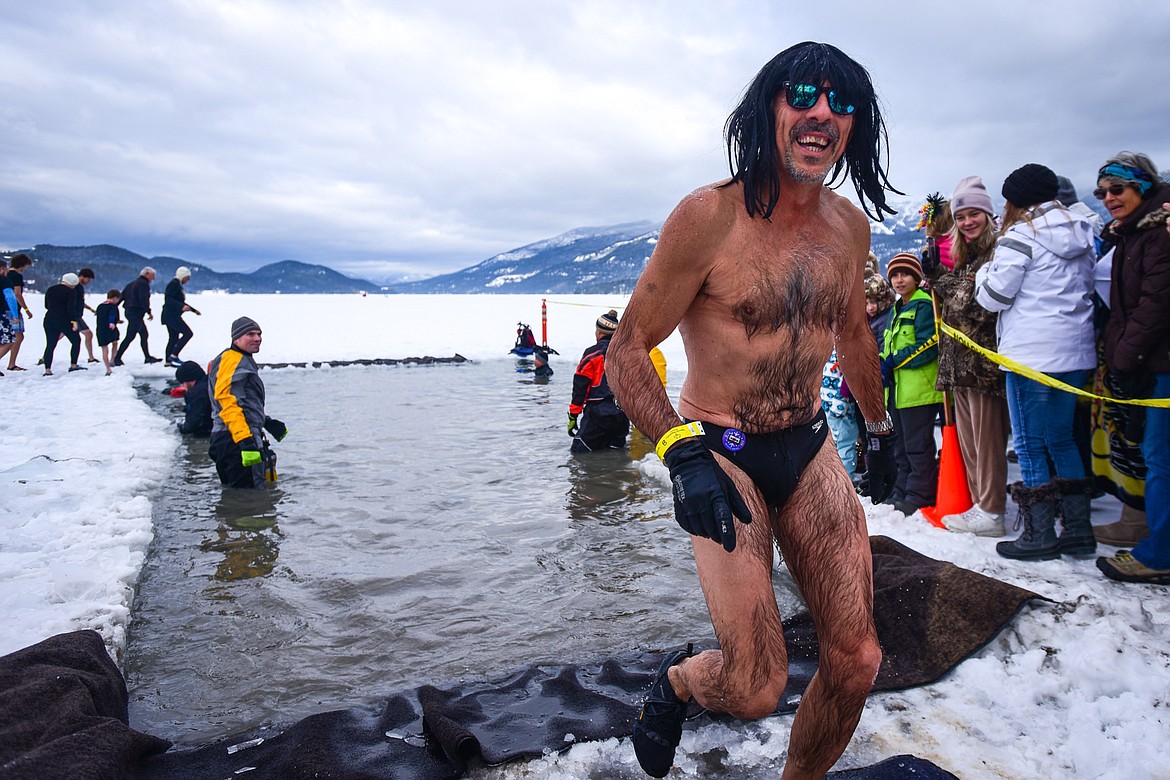 Participants step out of Whitefish Lake during the Penguin Plunge on Saturday, Feb. 5. Organized by the Law Enforcement Torch Run as part of the Whitefish Winter Carnival, the event raised over $60,000 for Special Olympics Montana. (Casey Kreider/Daily Inter Lake)